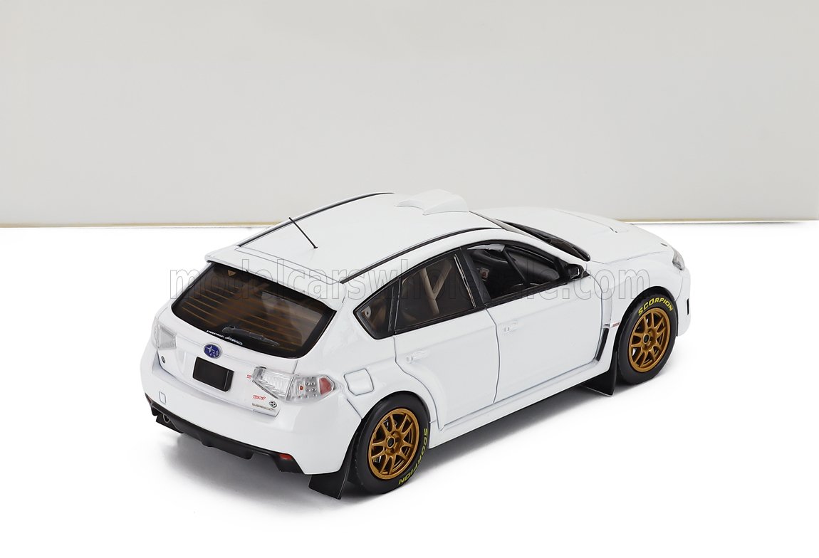 SUBARU - IMPREZA WRX STi N 0 RALLY SPEC 2011 - CON 2 JUEGOS DE LLANTAS Y NEUMÁTICOS - BLANCO. Maqueta de coche a escala en Vroomi