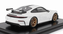 White Porsche 911 GT3 model car with gold wheels and rear wing on display, available on Vroomi