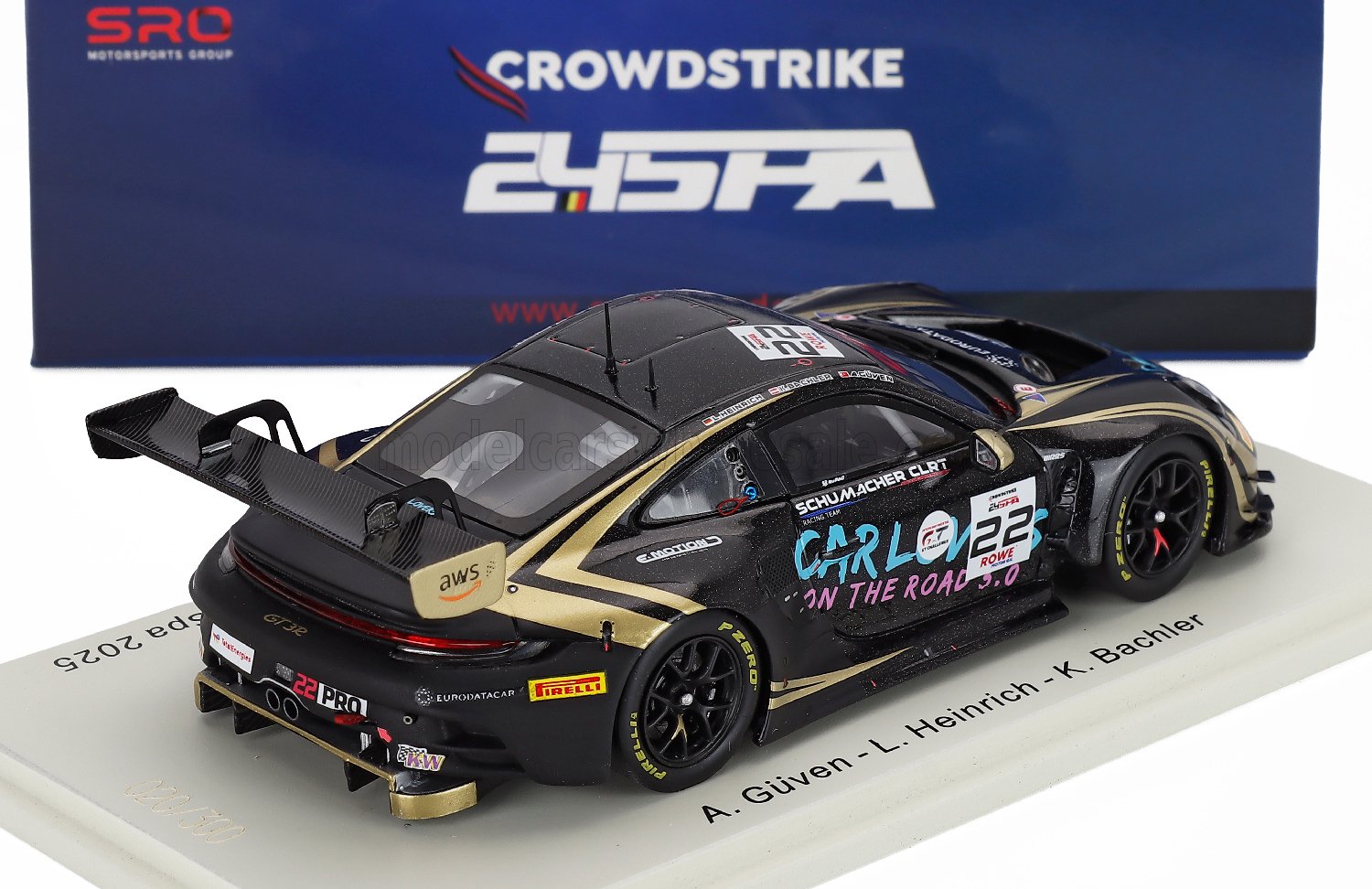 Black and gold scale model car with racing decals, displayed at Vroomi for collectors.