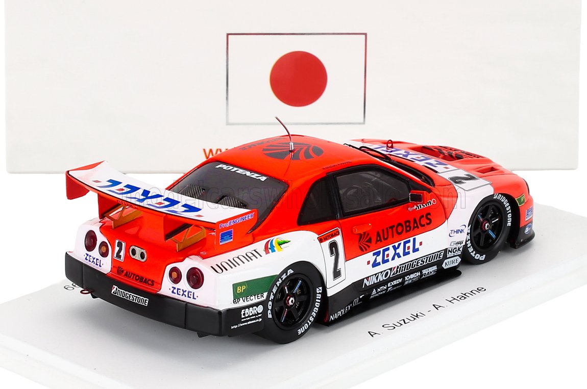 1/43 scale Nissan GT-R race car model with Autobacs Zexel livery, displayed with Japanese flag, available at Vroomi