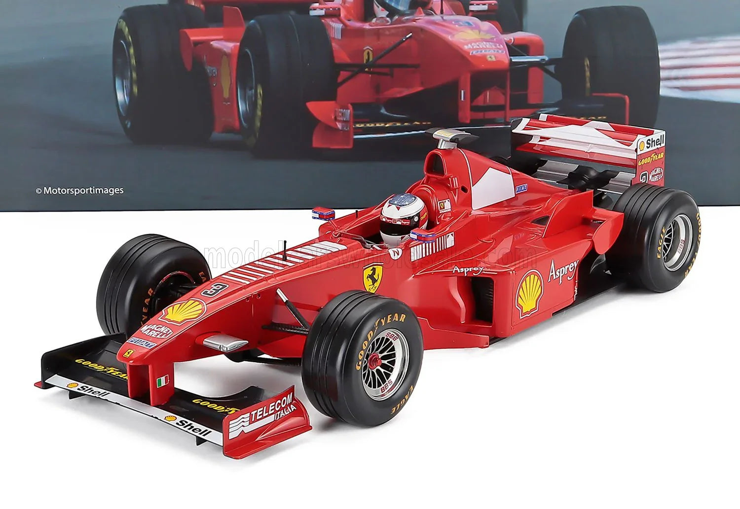 FERRARI - F1 F300 N.º 3 VENCEDORA DO GP DE FRANÇA DE 1998 MICHAEL SCHUMACHER - VERMELHO E BRANCO Modelo em escala no Vroomi