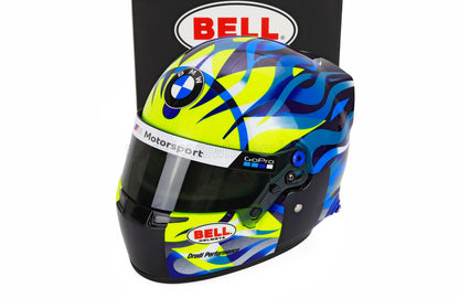 BMW Motorsport scale model car helmet by Bell, featuring GoPro and Drudi Performance logos, displayed at Vroomi