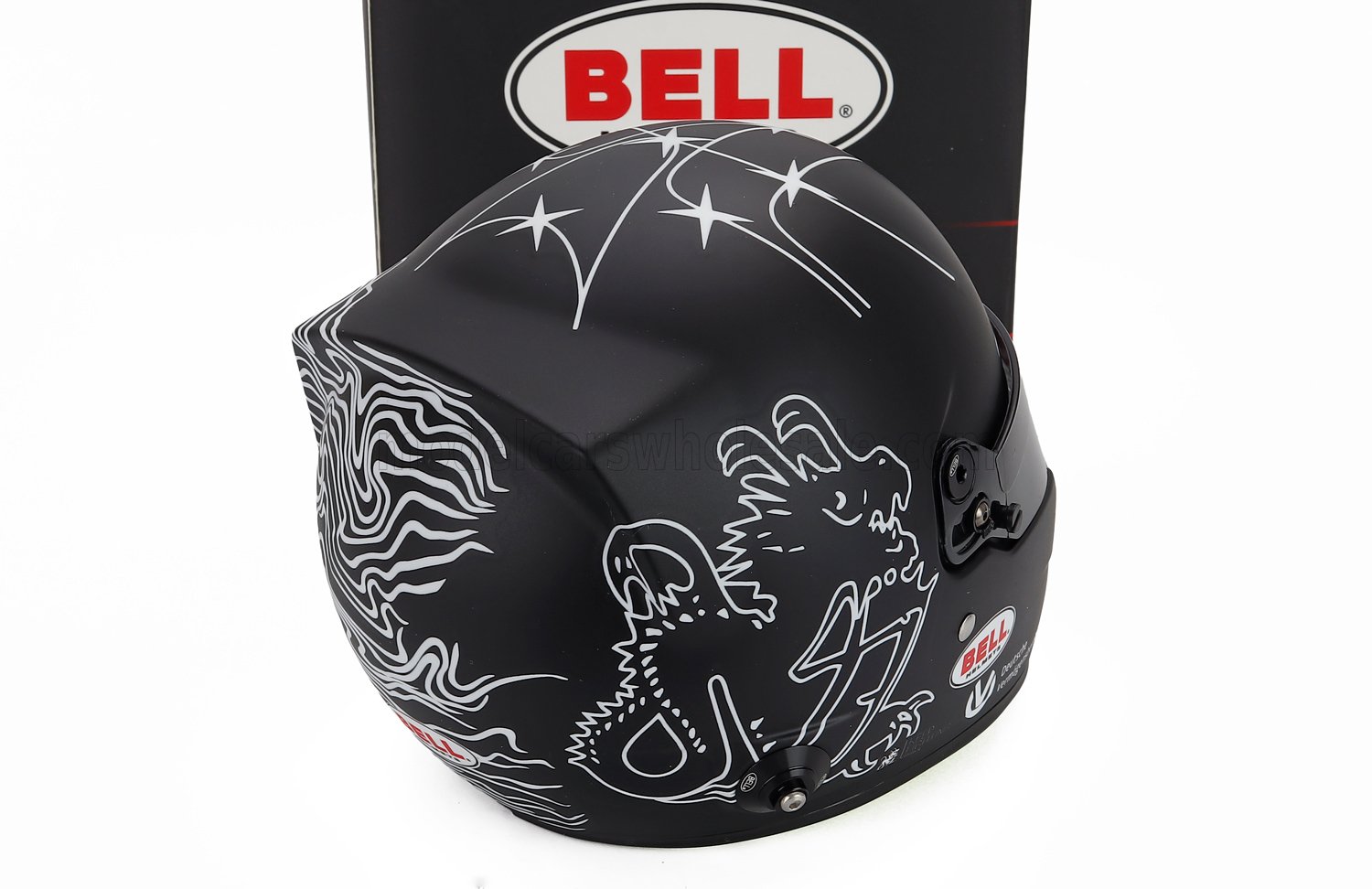 Black Bell racing helmet with white dragon design, displayed with box — scale model car accessory at Vroomi
