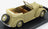Voiture miniature cabriolet vintage beige, capote ouverte et roue de secours, présentée sur socle noir — Vroomi