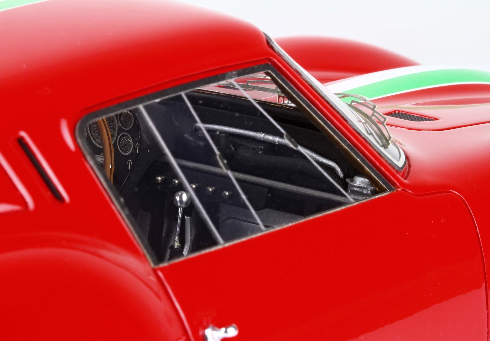 Red racing car model interior with detailed dashboard and roll cage, available on Vroomi
