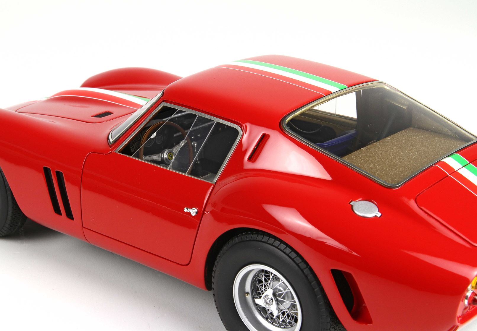 Red vintage model car with Italian flag stripe on roof, wire spoke wheels, available at Vroomi