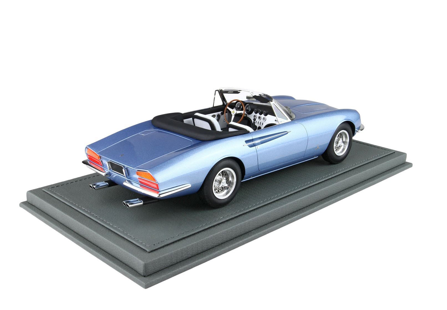 Blue classic convertible model car with white and black interior on gray display base, available on Vroomi