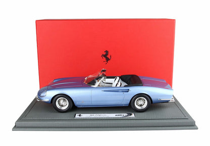 Blue Ferrari 365 California convertible model car displayed on gray base with red Ferrari backdrop, available on Vroomi