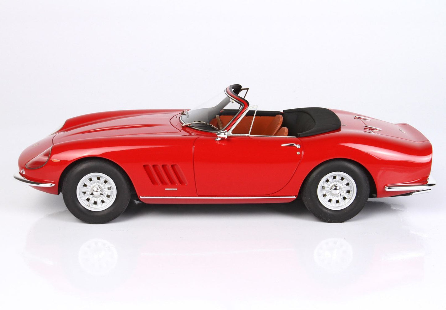 Red classic convertible sports car model with tan interior and black soft top, offered on Vroomi