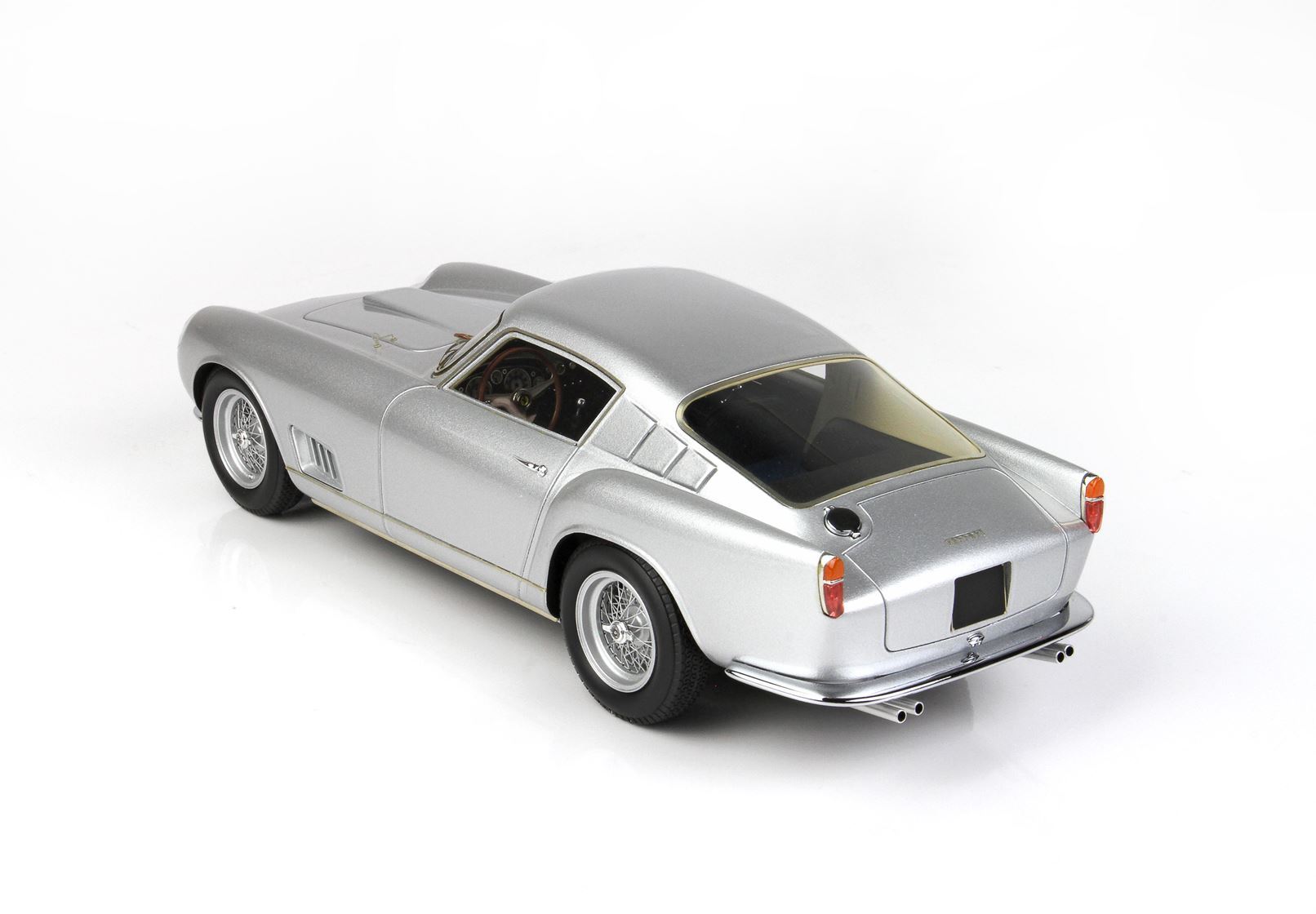 Silver vintage sports car model with wire wheels, detailed interior, available on Vroomi platform