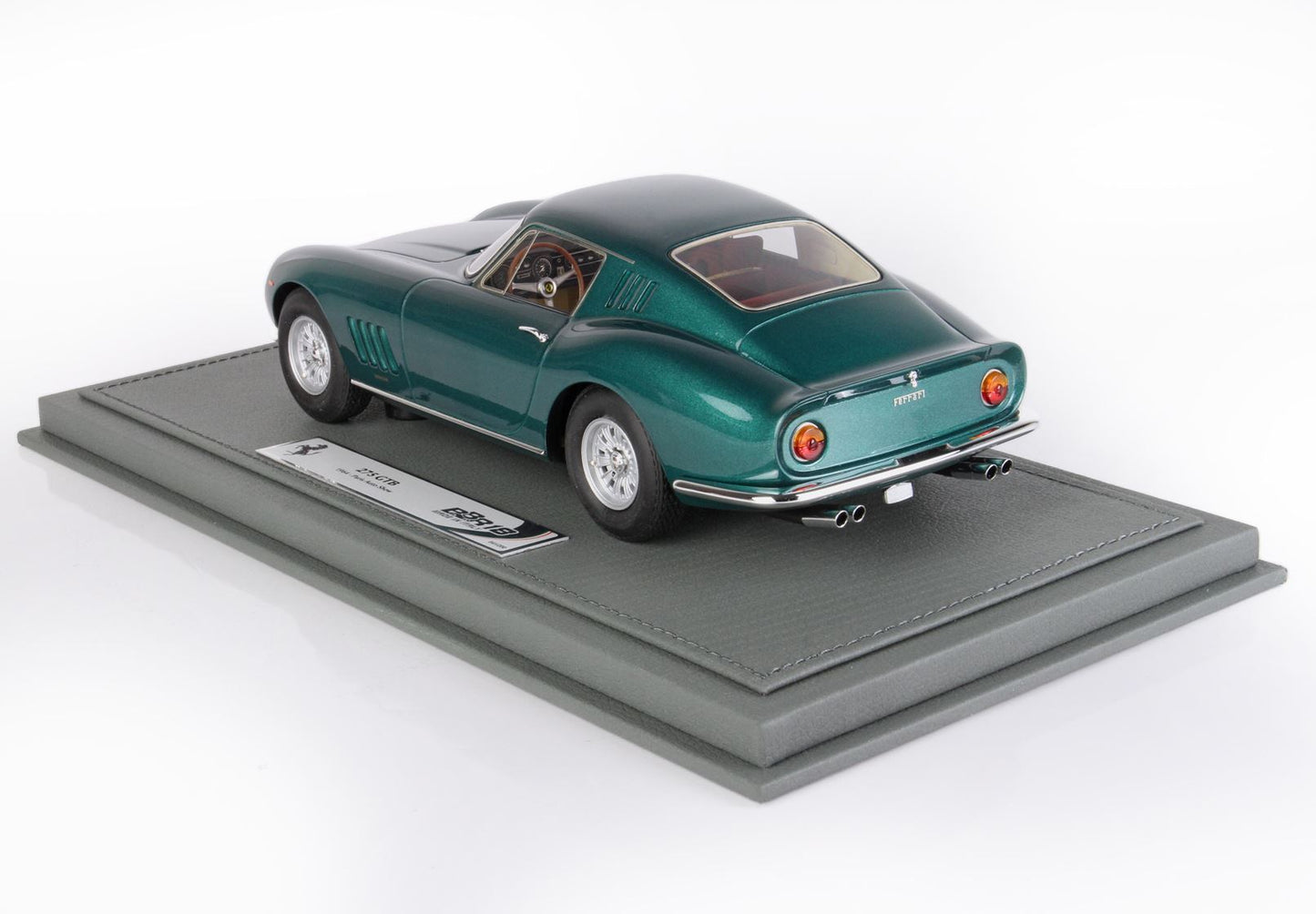 Green Ferrari 275 GTB model car on gray leather display base, available on Vroomi replica collection