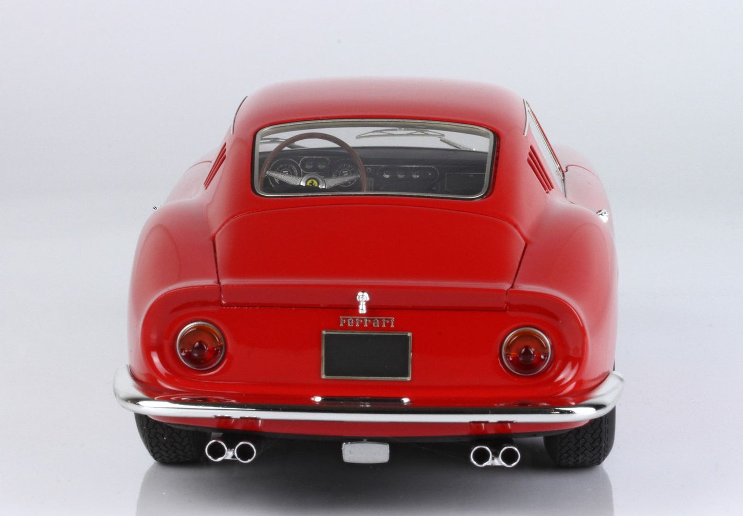 Rear view of classic red Ferrari vintage sports car with dual exhausts, available on Vroomi