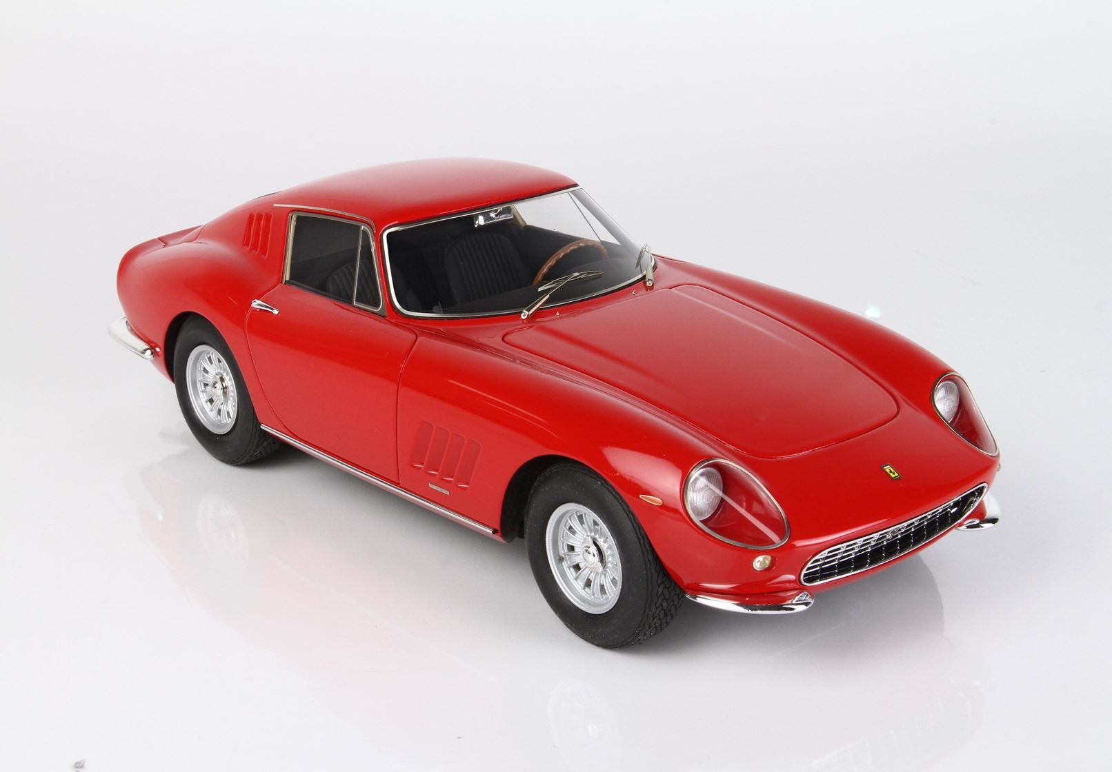 Red classic Ferrari model car on white background, sporty coupe design, available via Vroomi