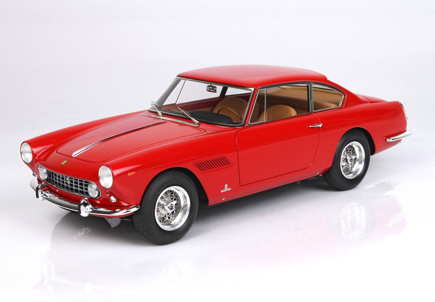 Red vintage Ferrari model car with tan interior on white background, also available on Vroomi