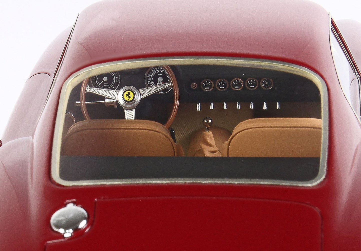 Rear view of classic red Ferrari dashboard with wooden steering wheel and tan leather seats, available on Vroomi