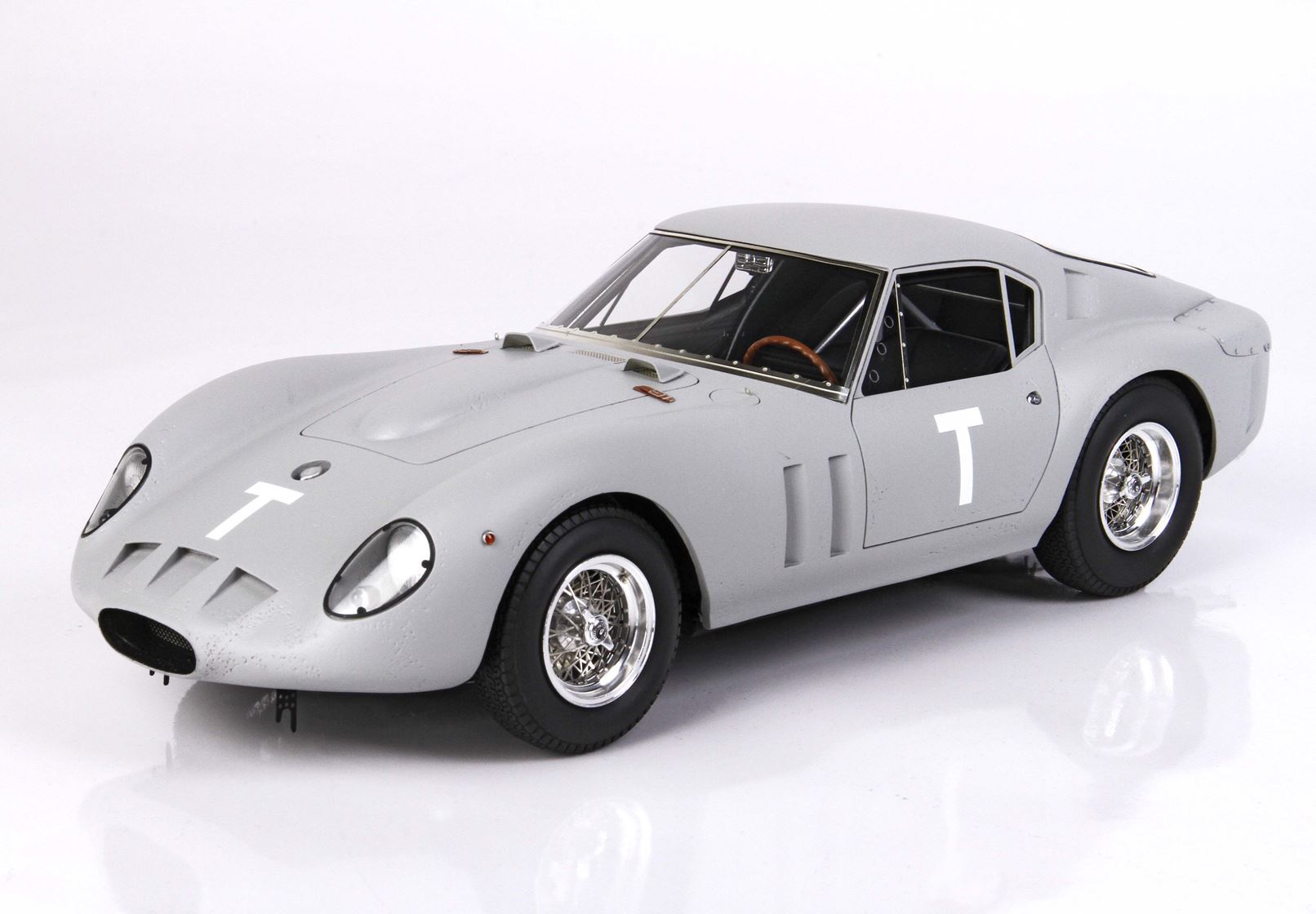 Classic gray vintage race car with white T decals, detailed wire wheels, available on Vroomi