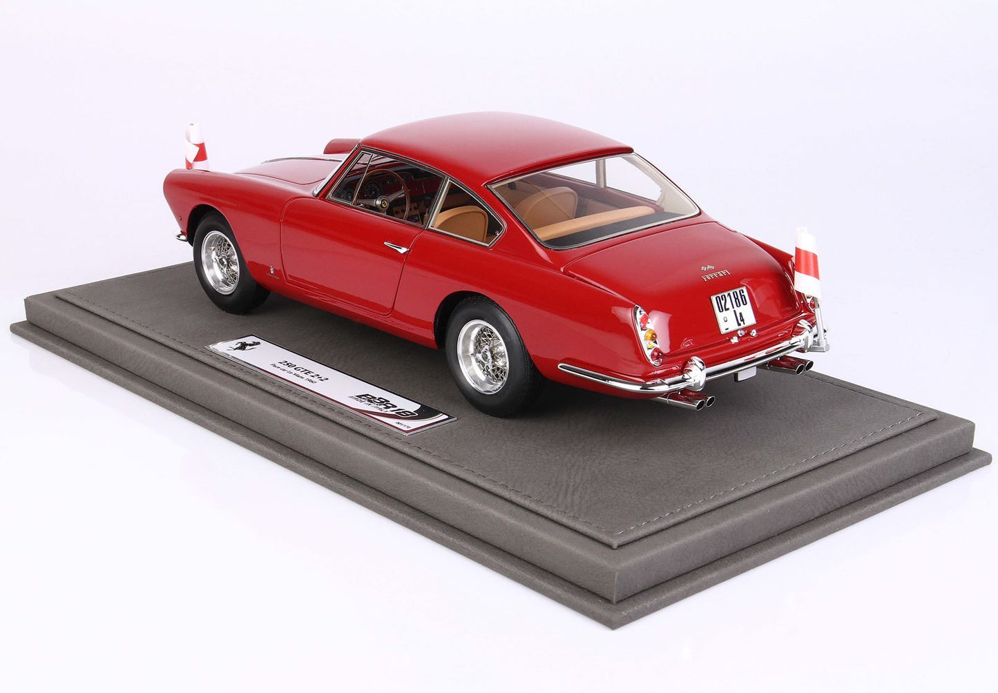 Red Ferrari 250 GTE 2+2 scale model on a gray display base, available through Vroomi platform