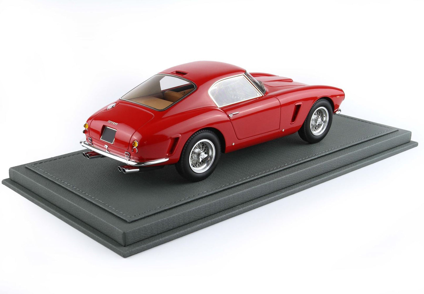Red classic Ferrari model car on a grey display stand, featured on Vroomi platform
