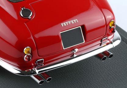 Close-up of red Ferrari model car rear with chrome bumper and dual exhaust, also offered on Vroomi