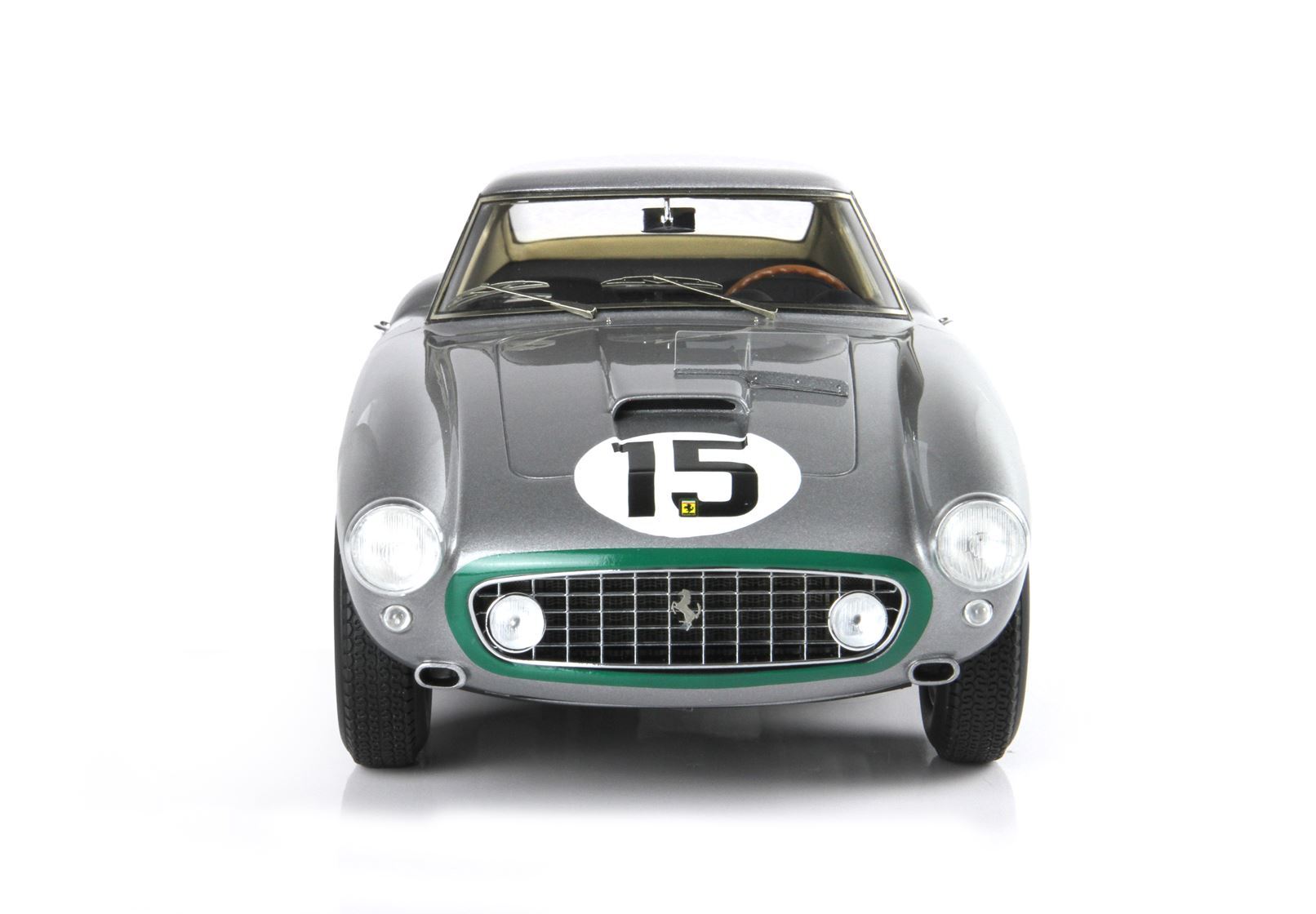 Front view of vintage gray Ferrari race car with number 15, green grille highlight, available on Vroomi