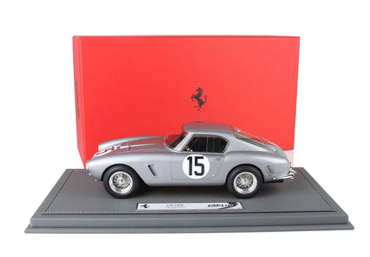 Silver Ferrari 250 SWB model car with number 15 on door, displayed on gray base with red Ferrari box, sold on Vroomi
