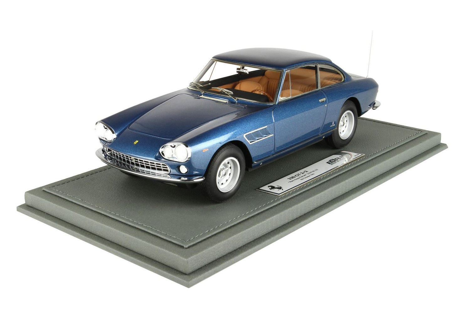 Blue Ferrari 330 GT 2+2 model car with tan interior on display base, available through Vroomi