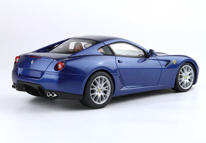 Blue metallic Ferrari luxury sports car rear side view on white background, now offered on Vroomi platform