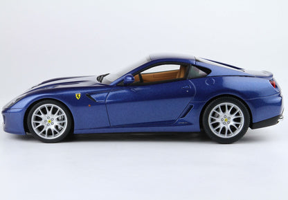 Blue Ferrari sports car model with tan interior, sleek design, now featured on Vroomi