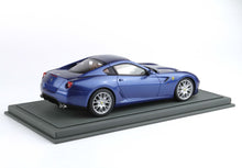 Blue Ferrari model car on display base, detailed replica available on Vroomi platform