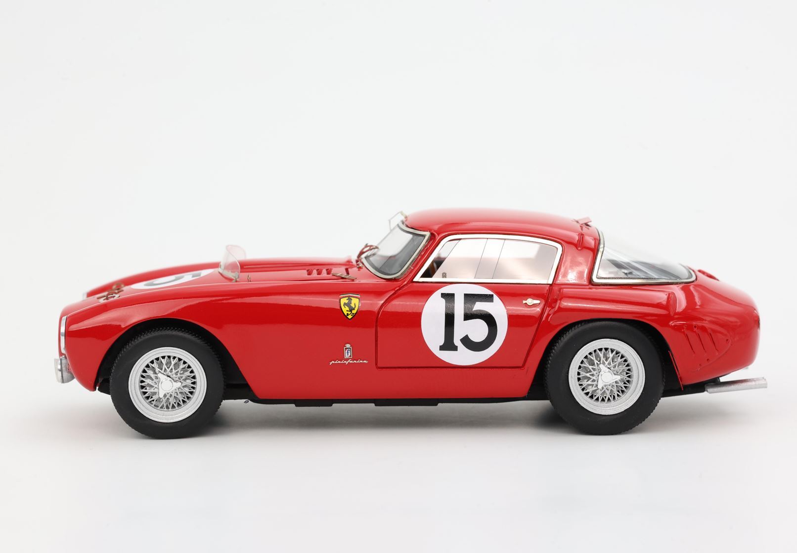 Red vintage Ferrari race car model with number 15 and wire wheels, available on Vroomi