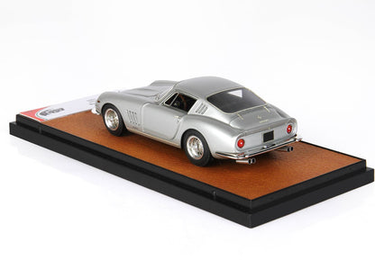 Silver Ferrari 275 GTB model car displayed on brown leather base, available on Vroomi platform
