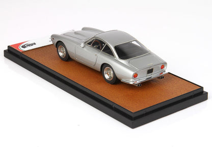 Silver vintage Ferrari model car on leather-textured display base available on Vroomi platform