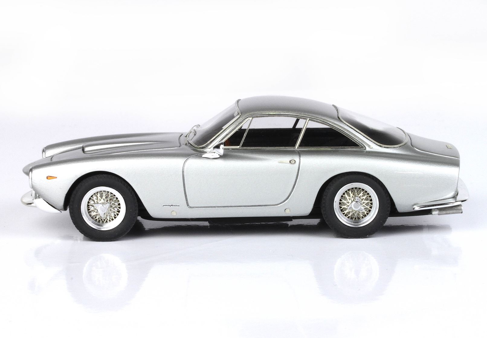 Silver vintage coupe car model with wire spoke wheels, shown from side, available on Vroomi