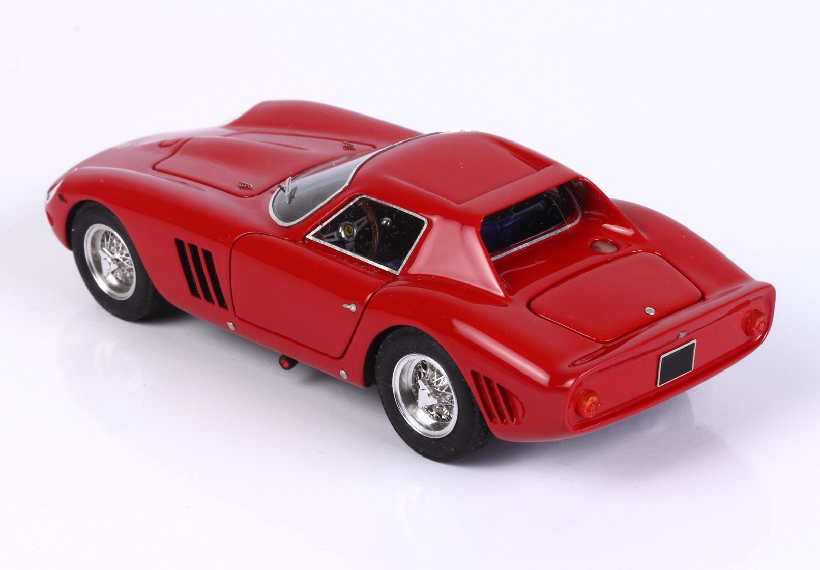 Red vintage sports car model with sleek curves and wire-spoke wheels, available on Vroomi platform