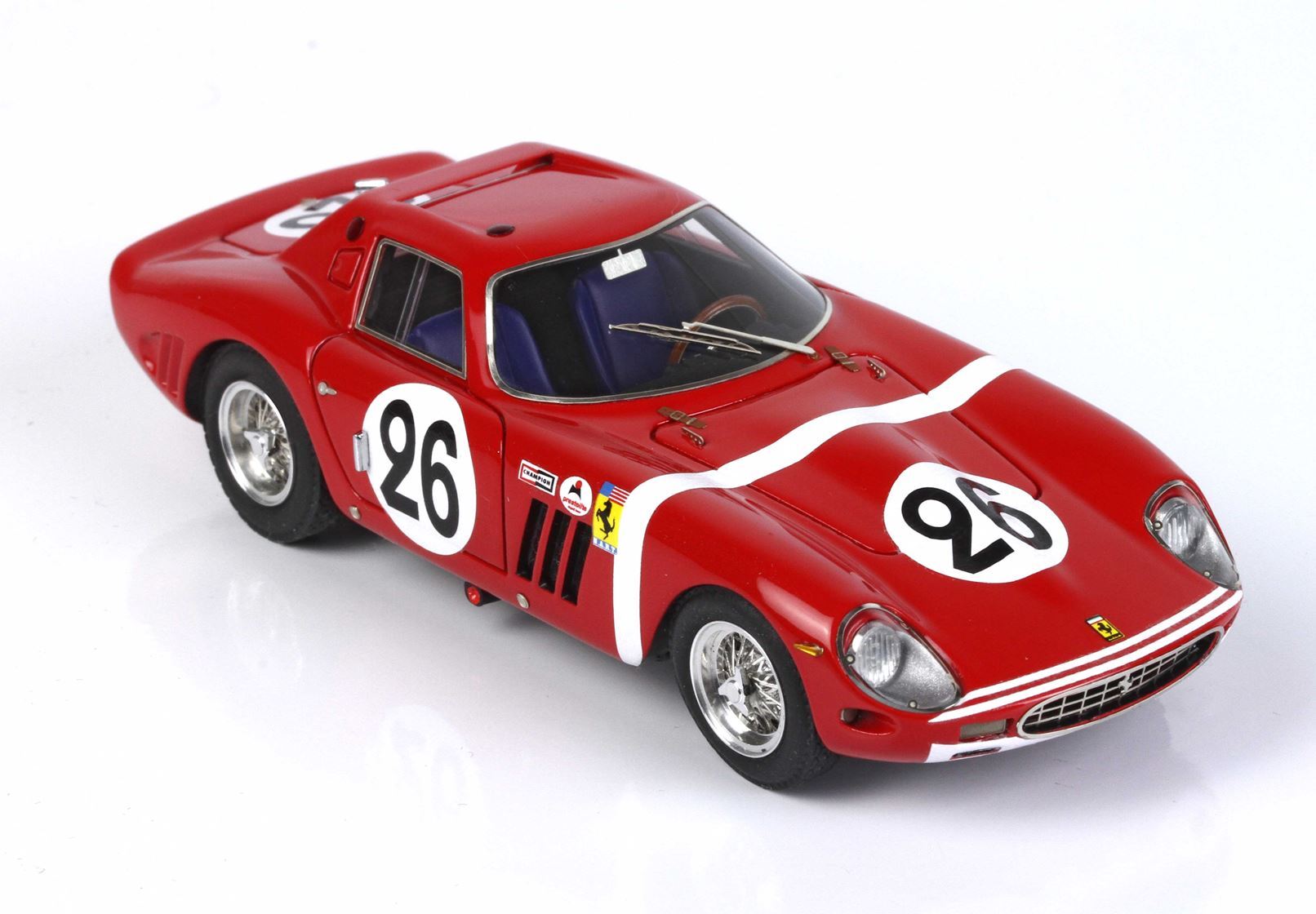 Red vintage Ferrari race car model with number 26 decals, detailed interior, and wire wheels, available on Vroomi