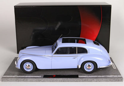 Light blue classic model car displayed on marble base with black and red backdrop, available on Vroomi