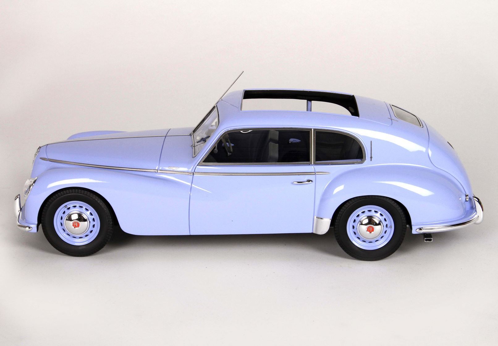 Light blue vintage classic car model with curved design and sunroof, now accessible via Vroomi