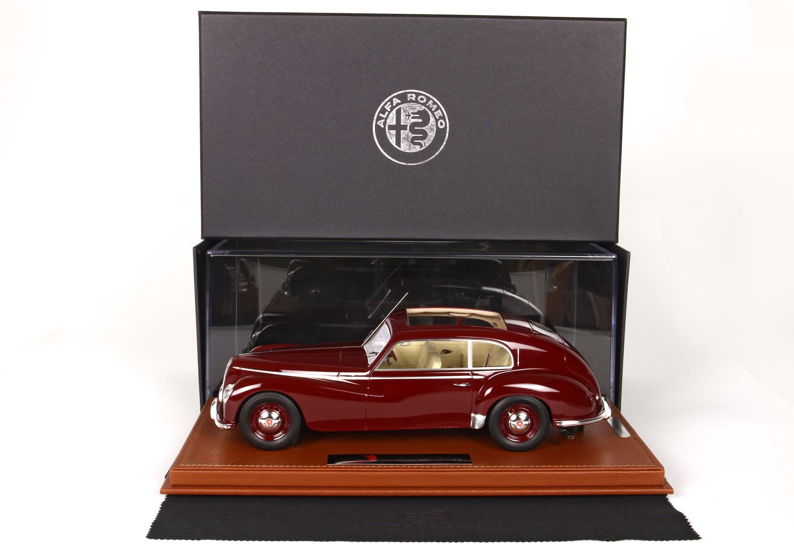Maroon vintage Alfa Romeo model car in clear display case with black Alfa Romeo box, offered via Vroomi
