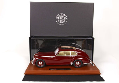 Maroon vintage Alfa Romeo model car in clear display case with black Alfa Romeo box, offered via Vroomi