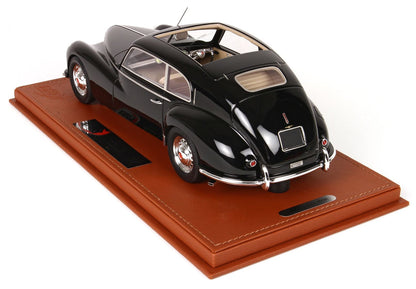Black vintage model car on brown leather display base with chrome details, offered on Vroomi