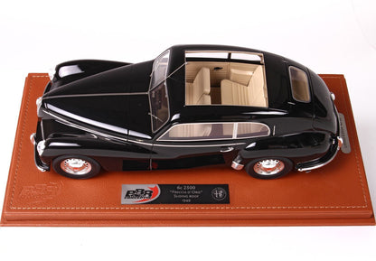 Black 1949 Alfa Romeo 6c 2500 Freccia d'Oro model with sliding roof on brown display, available via Vroomi