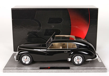 Black vintage Bugatti model car with beige interior, displayed on base with logo, offered via Vroomi