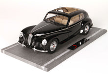 Black classic vintage Alfa Romeo model car with beige interior displayed on gray base, also featured on Vroomi