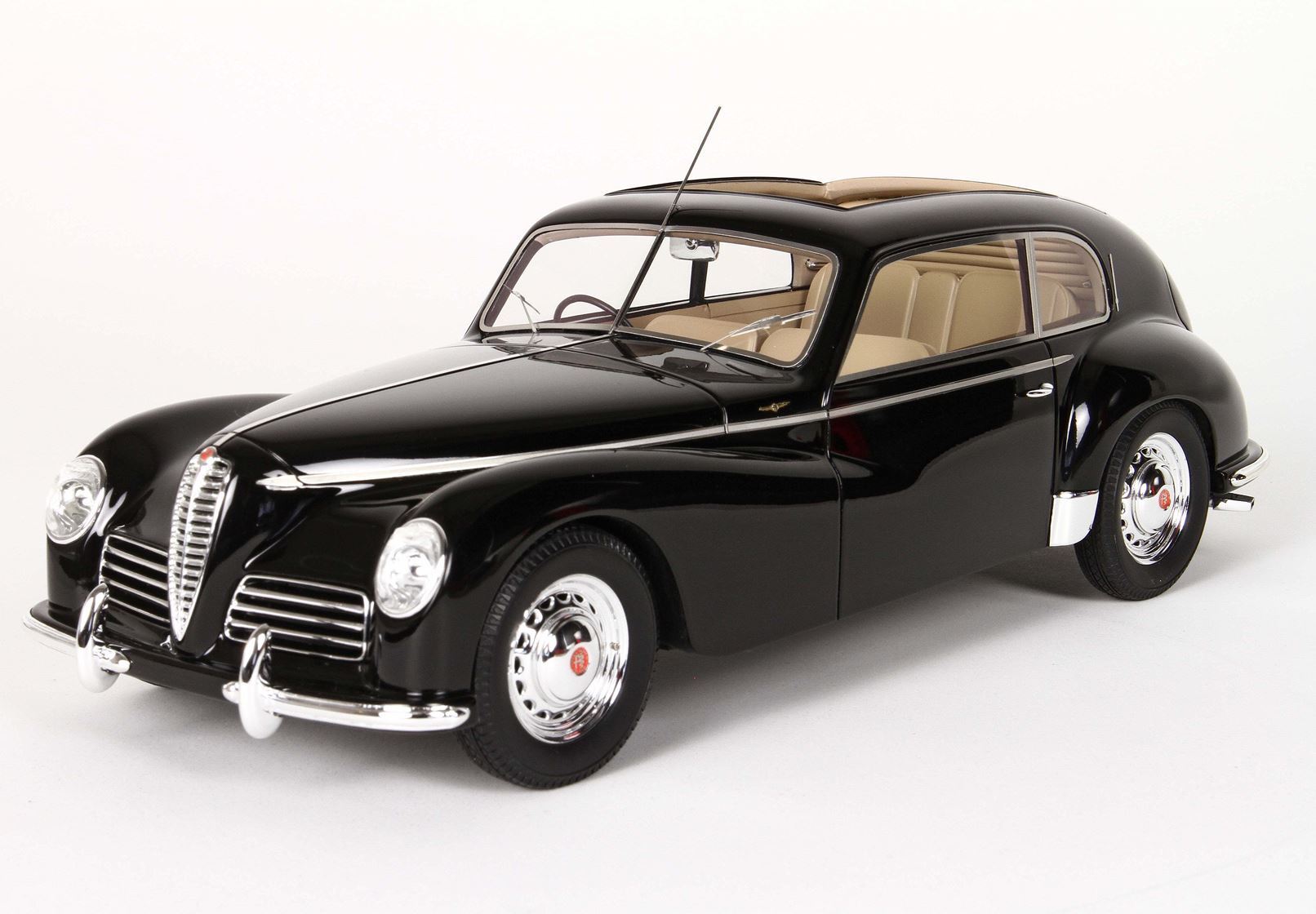 Black vintage Alfa Romeo model car with chrome grille and beige interior, now offered on Vroomi