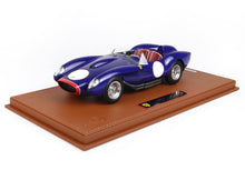 Blue Ferrari 250 TR model car with red interior on leather display base, available on Vroomi