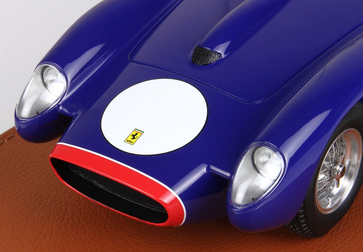 Blue vintage Ferrari model car front with white circle and red-bordered grille, offered on Vroomi