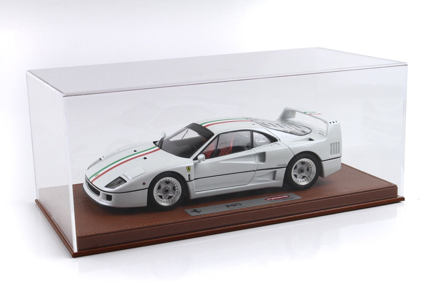 White Ferrari F40 model car with Italian flag stripe, displayed in clear case on brown base, available on Vroomi
