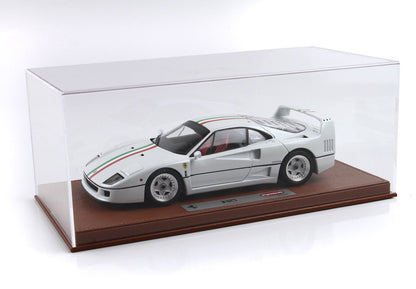 White Ferrari F40 model car with Italian flag stripe, displayed in clear case on brown base, available on Vroomi