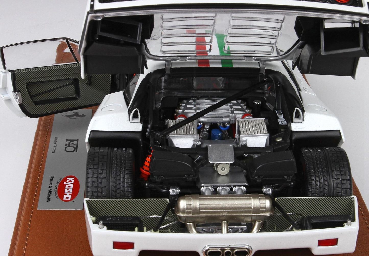 Detailed white Ferrari F40 model with open rear engine hood and doors, displayed on leather base, now offered on Vroomi