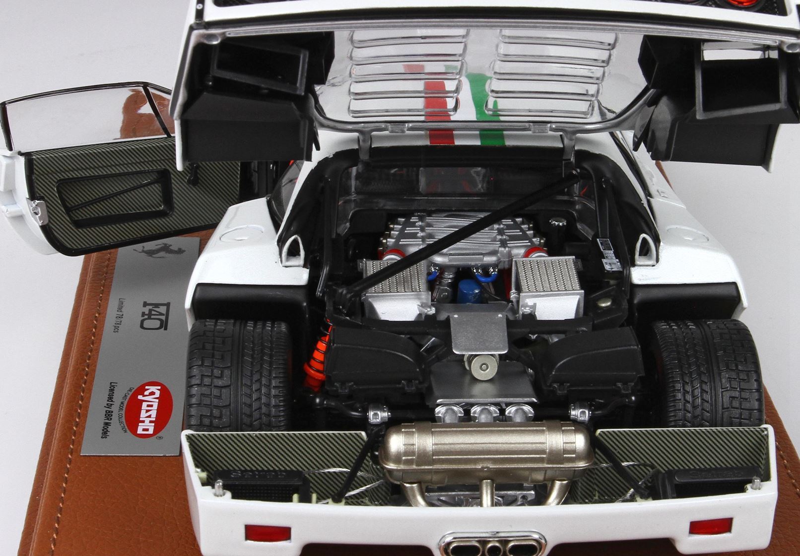 Detailed white Ferrari F40 model with open rear engine hood and doors, displayed on leather base, now offered on Vroomi